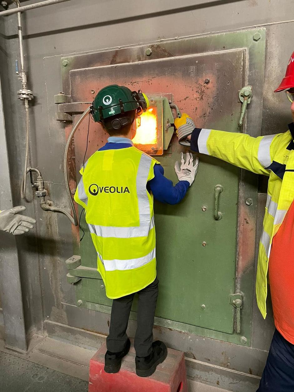 Photo shows a student looking into the furnace